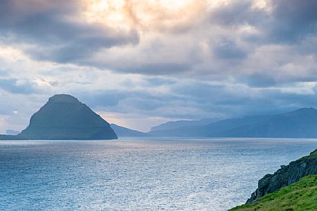 View of Koltur Island in a cloudy evening from Streymoy island, Faeroe islands, Denmark, Europe View of Koltur Island in a cloudy evening from Streymoy island, Faeroe islands, Denmark, Europe