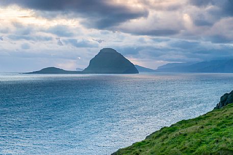 View of Koltur Island in a cloudy evening from Streymoy island, Faeroe islands, Denmark, Europe View of Koltur Island in a cloudy evening from Streymoy island, Faeroe islands, Denmark, Europe