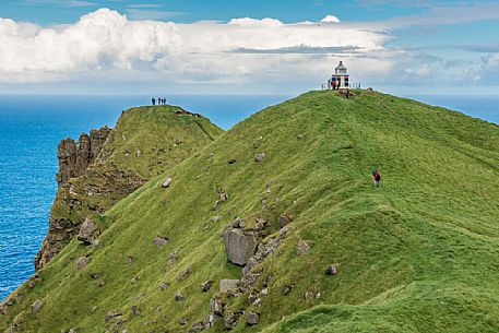 Tourists at Kallur Lighthouse, Kalsoy Island (Kalsø), Faeroe Islands, Denmark, Europe Tourists at Kallur Lighthouse, Kalsoy Island (Kalsø), Faeroe Islands, Denmark, Europe