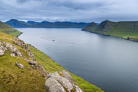 Above view of Funningur fjord with fish farming, Eysturoy Island, Faeroe islands, Denmark, Europe Above view of Funningur fjord with fish farming, Eysturoy Island, Faeroe islands, Denmark, Europe