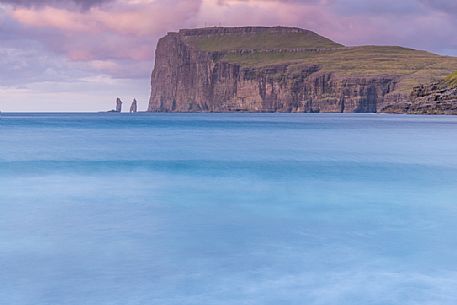 Wild sea and in the background the sea stacks of Risin and Kellingin, just off the northern coast of the island of Eysturoy from Tjornuvik village, Streymoy island, Faeroe islands, Denmark, Europe