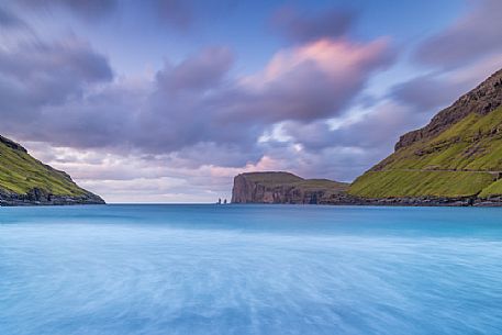 Wild sea and in the background the sea stacks of Risin and Kellingin, just off the northern coast of the island of Eysturoy from Tjornuvik village, Streymoy island, Faeroe islands, Denmark, Europe