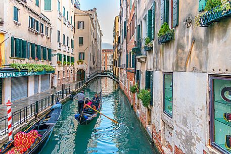 Tourists in the gondola in Venice's canal, Venice, Veneto, Italy, Europe