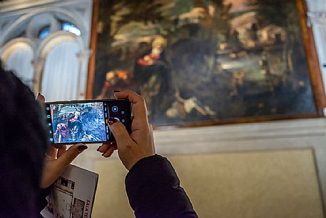Tourist taking a picture inside the Scuola Grande di San Rocco, Venice, Veneto, Italy, Europe
