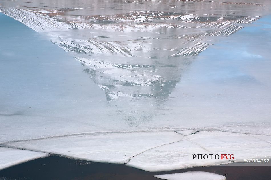 Mount Kirkjufell reflected on ice