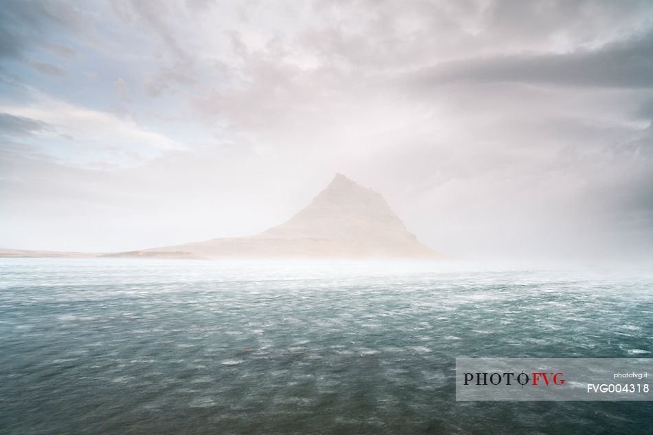Mount kirkjufell from the Grundarfjordur bay in storm with 100 km/h winds