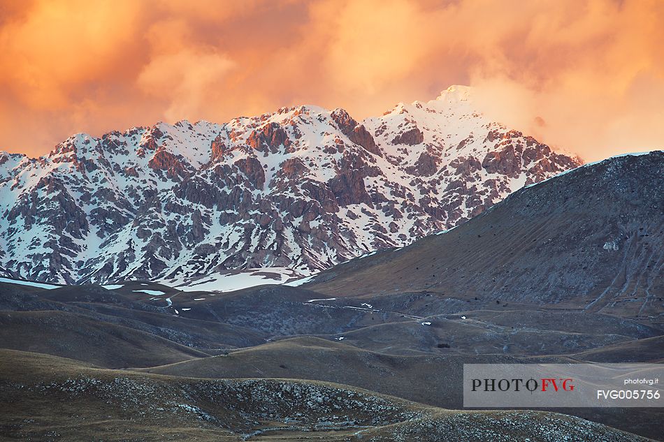 A sunset clouds adorned sky above Mount Prena. Below the mountain the grasslands of Campo Imperatore, Gran Sasso national park.