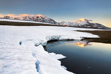 Racollo Lake in a spring sunset. Mount Prena and Mount Camicia in the background, Gran Sasso national park