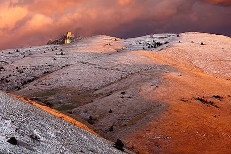 Rocca Calascio, a beautiful medieval castle that rise above an abandoned village, after the first seasonal snowfall, Gran Sasso national park, Abruzzo, Italy