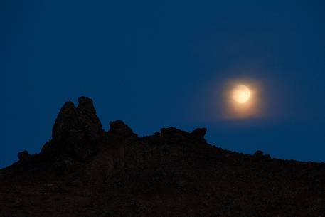 Moon rising from lava field in the Aldeyjarfoss waterfall area Moon rising from lava field in the Aldeyjarfoss waterfall area
