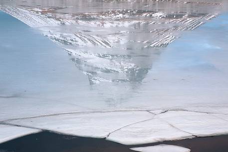 Mount Kirkjufell reflected on ice
