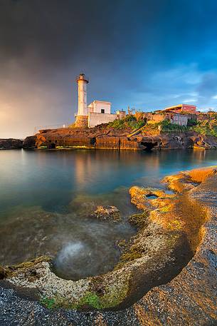 The old Ventotene Lighthouse built over the roman harbor at sunrise