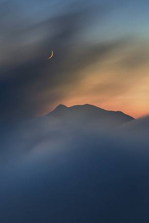 The moon rises over the Pollino National Park montains.