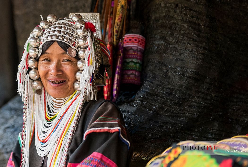 Akha hilltribe woman wearing traditional silver headpiece in Chiang Rai, Thailand