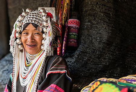 Akha hilltribe woman wearing traditional silver headpiece in Chiang Rai, Thailand