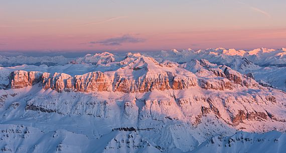 Wonderful sunrise from Marmolada mountain group, the highest peak of Dolomites, toward the Sella peak lighting, dolomites, Italy