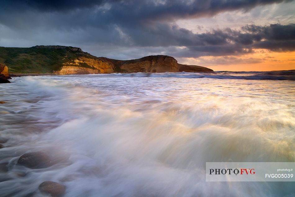 A wave of water and light, breaks in the beach of Santa Caterina di Pittinuri