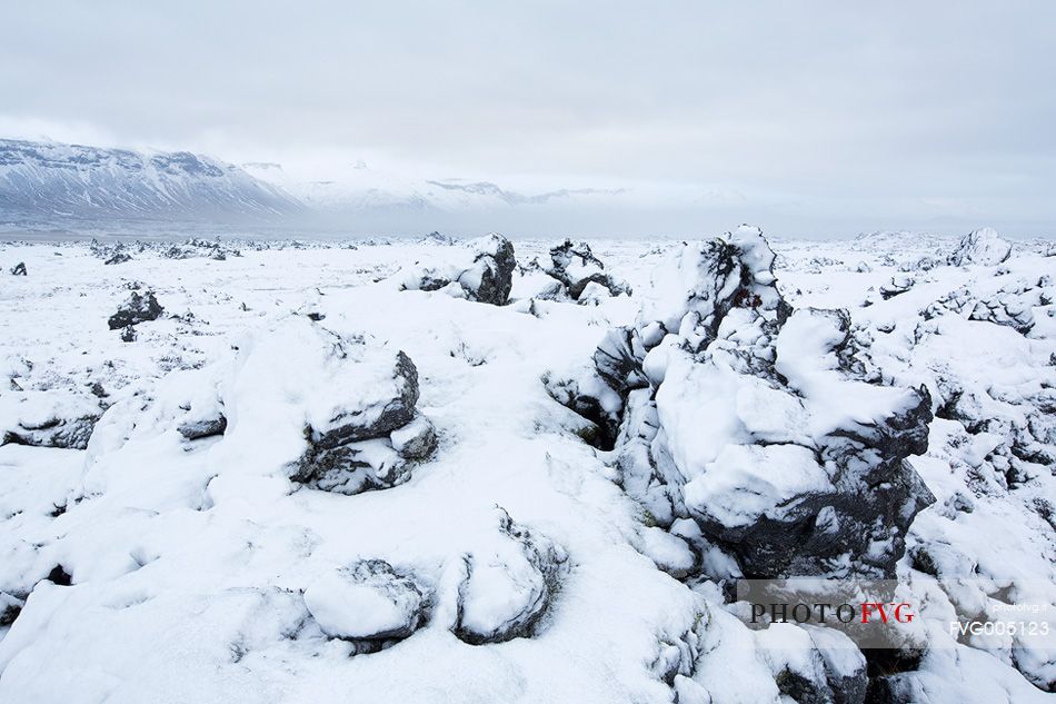 Volcanic rock formations covered by snow