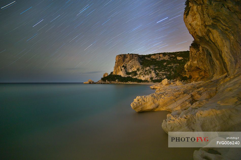 Cala Luna. One of the most famous bays of Sardinia photographed at night with the typical rocks eroded by the sea. The sea over the centuries has created fascinating caves on the sea