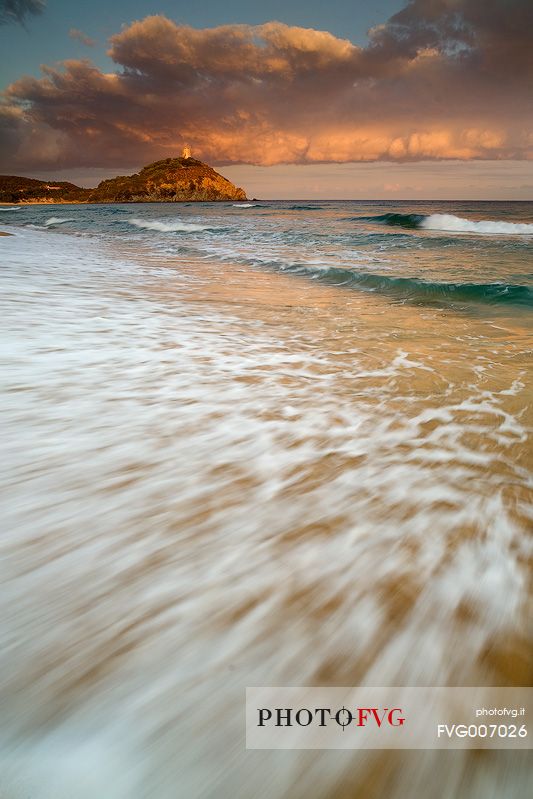 The sunset and the sea are the frame to the Spanish watchtower in Chia (Sardinia South West)