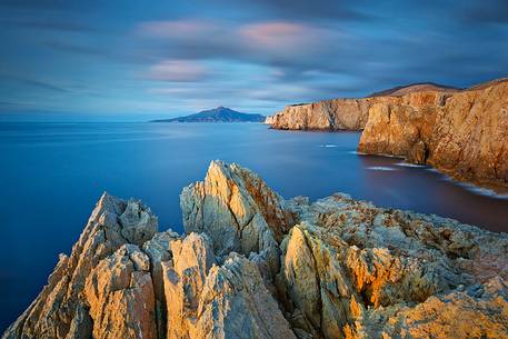 The famous cliffs of the west coast of Sardinia embellished by the light of the sunset in Cala Domestica