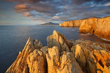 The famous cliffs of the west coast of Sardinia embellished by the light of the sunset in Cala Domestica