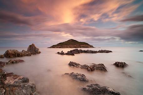 The small island of Campionna located in front of the homonymous beach taken at sunset. This coast is still little known and offers panoramic wild views, Teulada, Sulcis-Iglesiente, Sardinia