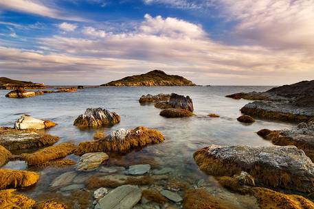 The small island of Campionna located in front of the homonymous beach taken at sunset. This coast is still little known and offers panoramic wild views, Teulada, Sulcis-Iglesiente, Sardinia, Italy