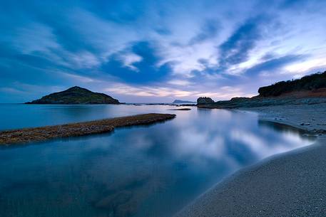 The small island of Campionna located in front of the homonymous beach taken at sunset. This coast is still little known and offers panoramic wild views,Teulada, Sulcis-Iglesiente, Sardinia, Italy