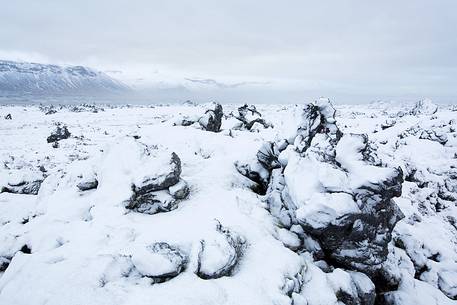 Volcanic rock formations covered by snow