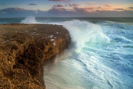 The waves break on the rocks at Capo Mannu during rough seas mistral