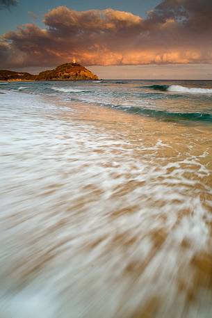 The sunset and the sea are the frame to the Spanish watchtower in Chia (Sardinia South West)