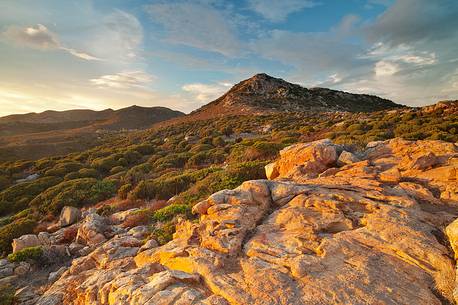 The warm light of the sunset illuminates the inside of the promontory of Capo Spartivento