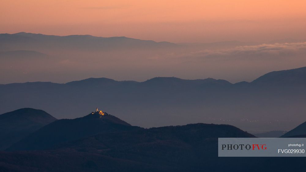 Nighfall from Mount Matajur towards Beata Vergine di Castelmonte sanctuary illuminated, Cividale, Julian Alps, Italy