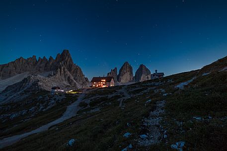 The north faces of the Tre Cime di Lavaredo peak and the Rifugio Locatelli hut at twilight, Sexten Dolomites, Trentino Alto Adige, Italy.