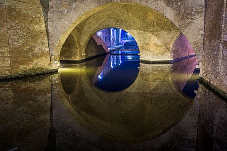 Details and reflections of Triple bridge, Ponte dei Trepponti, called Ponte Pallotta, Comacchio town, Ferrara, Emilia Romagna, Italy