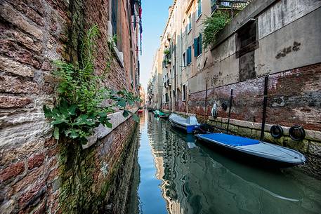 View of narrow canal with boat in Venice, Veneto, Italy, Europe
