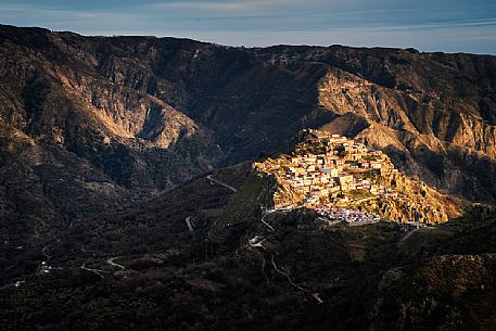 Roccaforte Del Greco illuminated by the light of a winter sunset