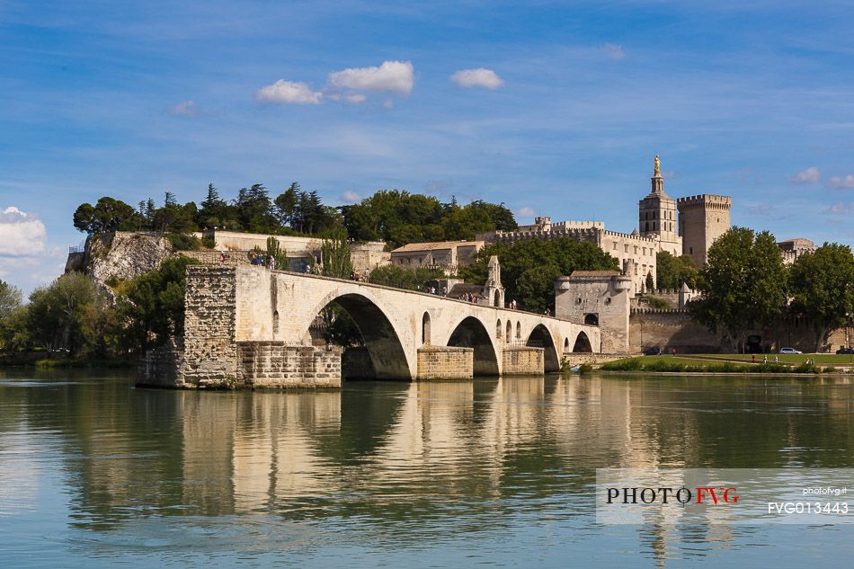 The city of Avignon across the Rhone River. The historic bridge of Avignon, Pont Saint-Benezet.