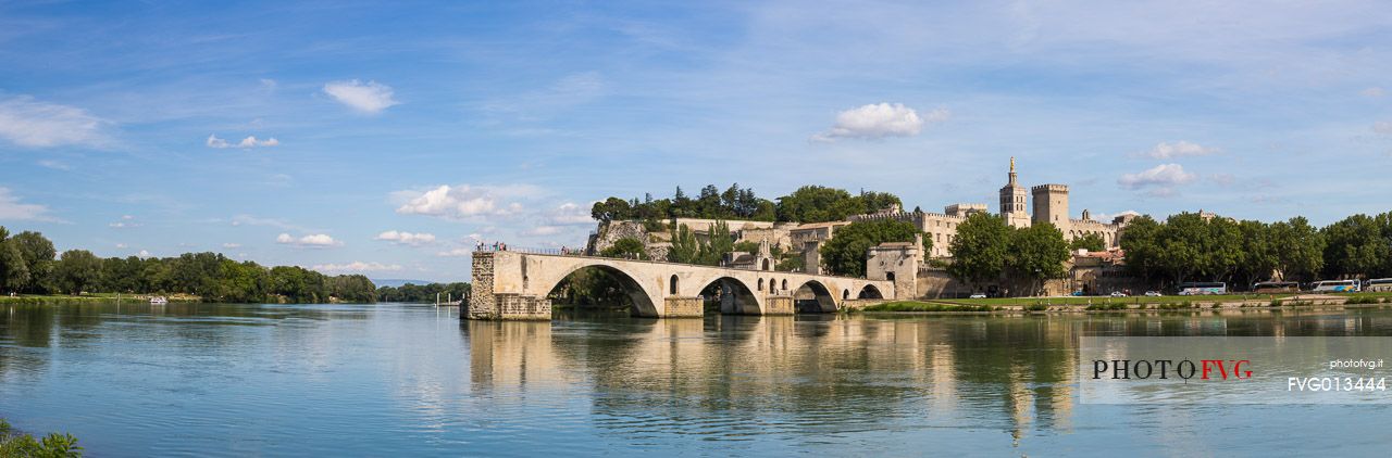 The city of Avignon across the Rhone River. The historic bridge of Avignon, Pont Saint-Benezet.