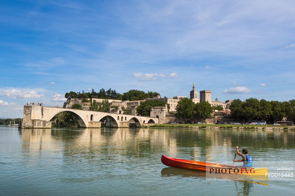 The city of Avignon across the Rhone River. The historic bridge of Avignon, Pont Saint-Benezet.