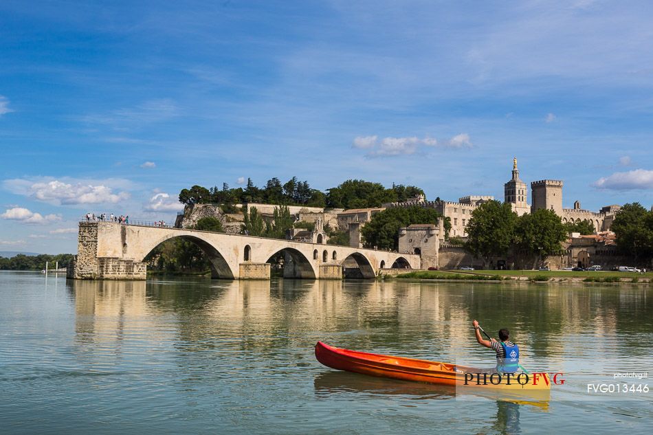 The city of Avignon across the Rhone River. The historic bridge of Avignon, Pont Saint-Benezet.