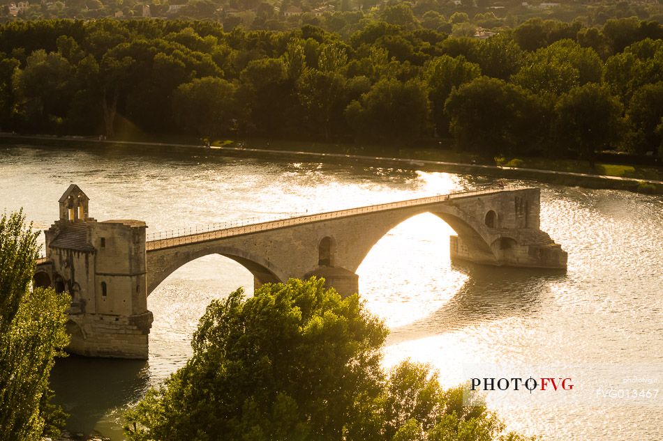 The city of Avignon across the Rhone River. The historic bridge of Avignon, Pont Saint-Benezet.