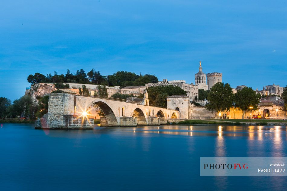 The city of Avignon across the Rhone River. The historic bridge of Avignon, Pont Saint-Benezet.