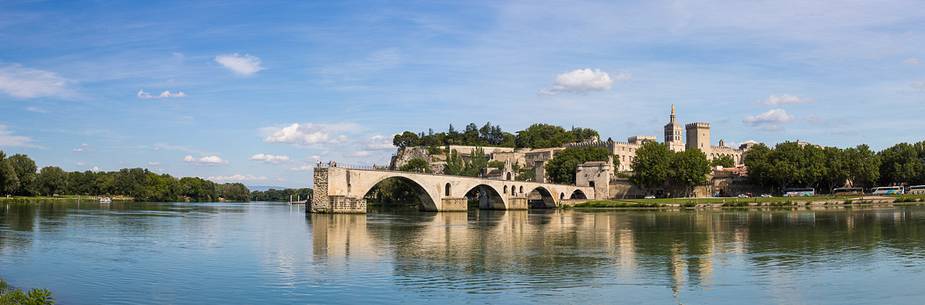 The city of Avignon across the Rhone River. The historic bridge of Avignon, Pont Saint-Benezet.