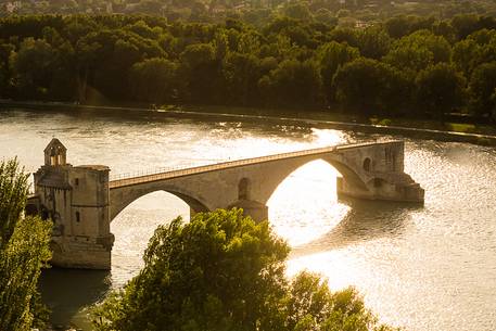 The city of Avignon across the Rhone River. The historic bridge of Avignon, Pont Saint-Benezet.