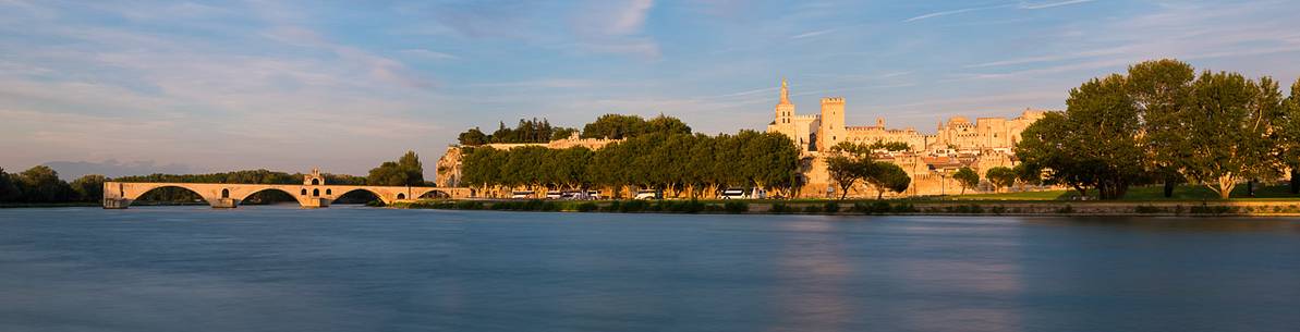 The city of Avignon across the Rhone River. The historic bridge of Avignon, Pont Saint-Benezet.