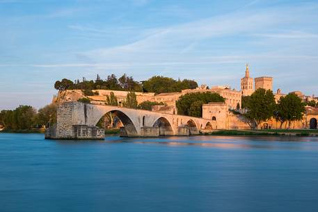 The city of Avignon across the Rhone River. The historic bridge of Avignon, Pont Saint-Benezet.