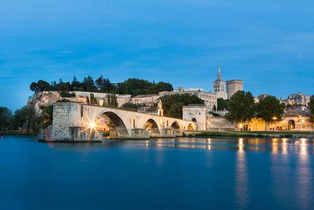 The city of Avignon across the Rhone River. The historic bridge of Avignon, Pont Saint-Benezet.