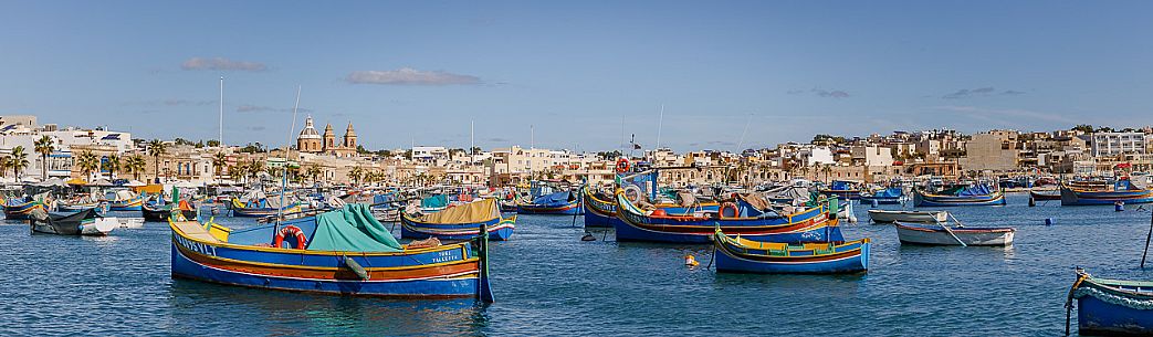 The historic city of Marsaxlokk on the island of Malta, famous for its colorful fishing boats called Iuzzu